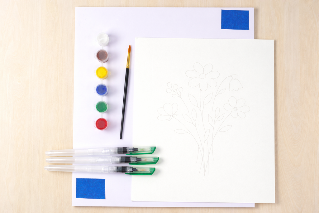 Color swatches, paintbrush, and markers on a white sheet of paper with a beige background