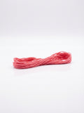 Studio shot of light carnation pink cotton embroidery floss skein, showcasing its soft texture and vibrant color.