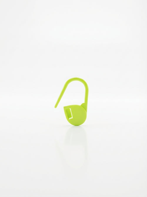 Apple green plastic crochet latch clip hook, close-up studio shot showing texture and color.