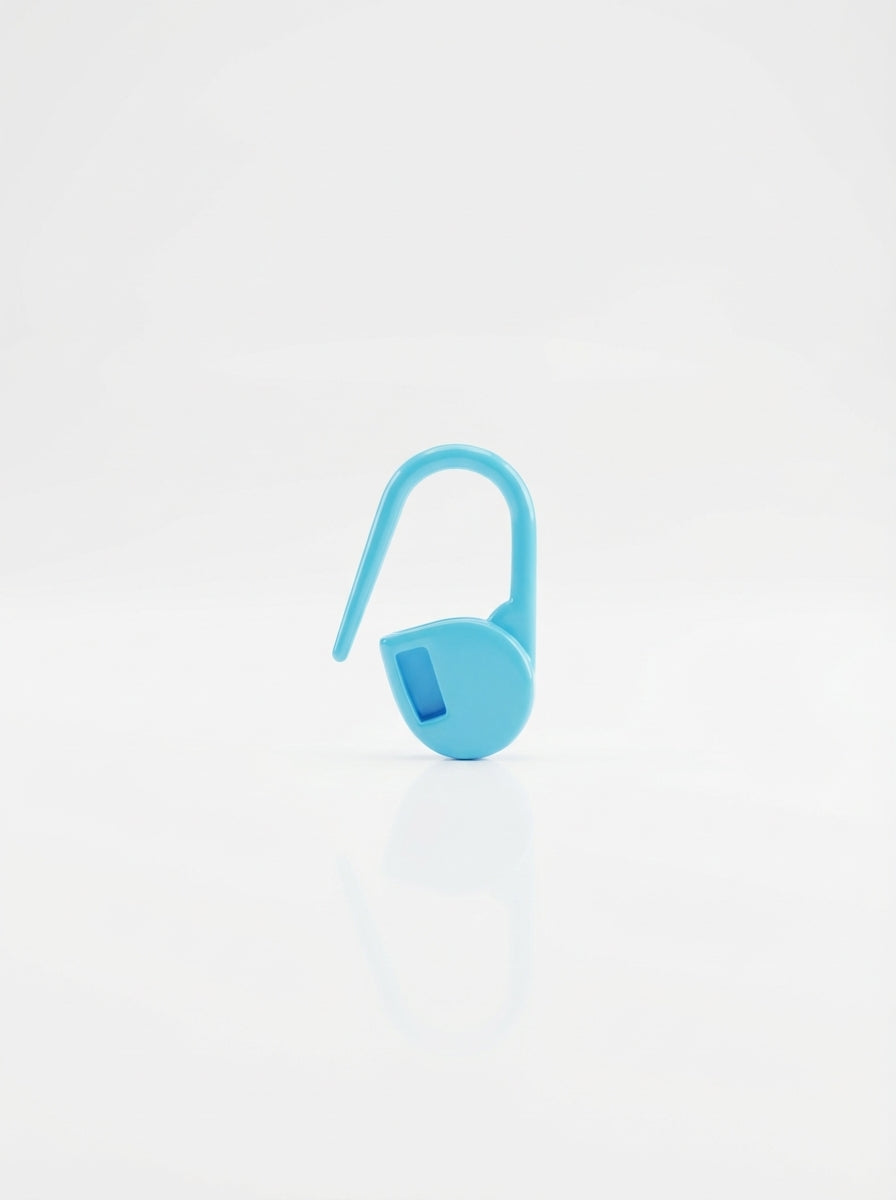 Studio shot of a blue crochet latch clip hook, a simple tool for organizing yarn projects.