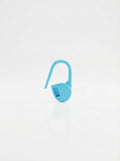 Studio shot of a blue crochet latch clip hook, a simple tool for organizing yarn projects.