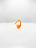 Orange plastic crochet latch clip hook for marking stitches, close-up studio shot, bright and clear.