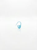 Close-up studio shot of a light blue plastic crochet latch hook clip with a smooth, clean finish.