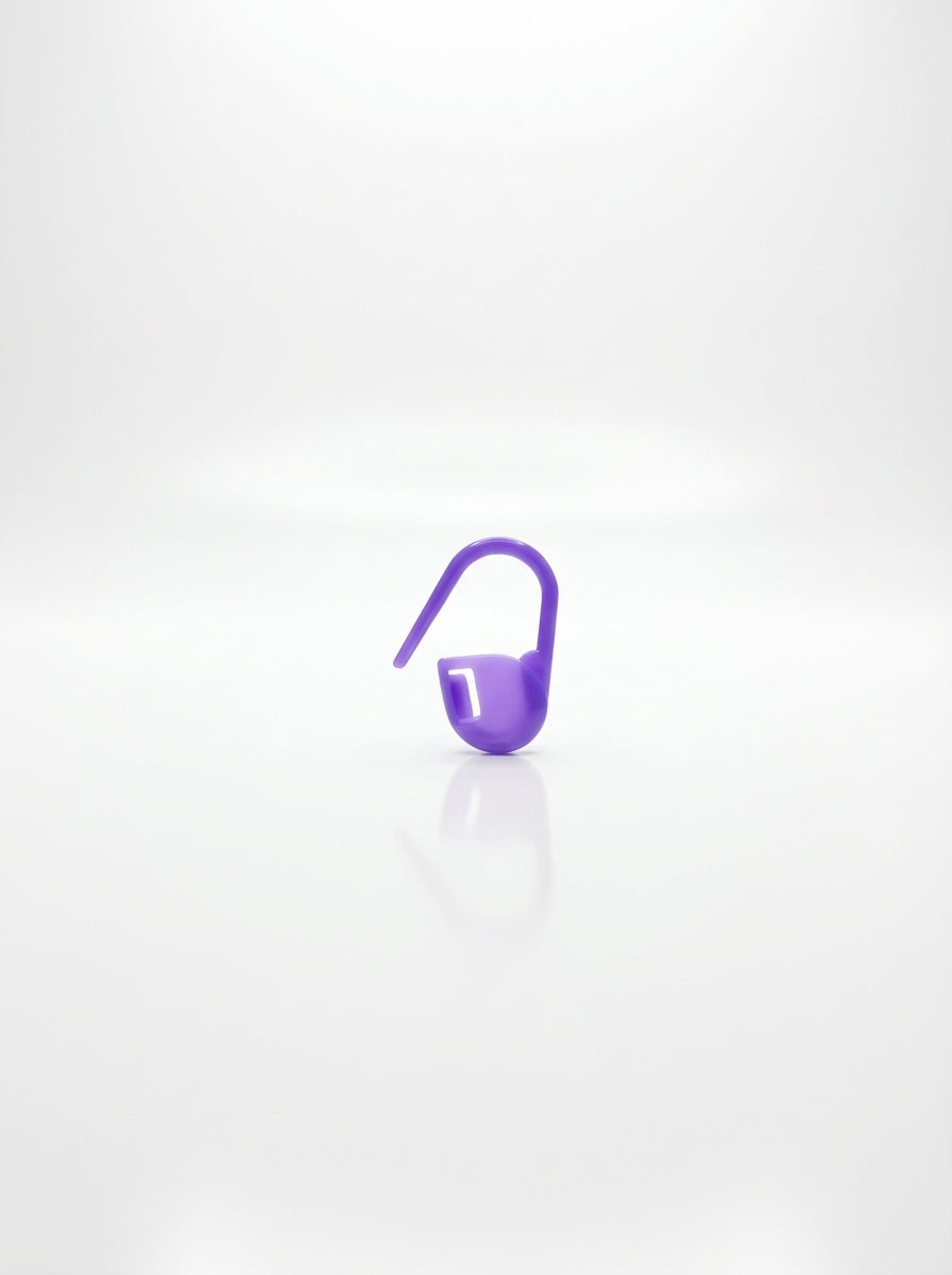 Studio shot of a purple plastic crochet latch hook tool for rug making and other yarn crafts.