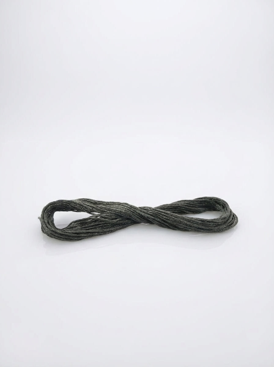Dark beaver gray cotton embroidery floss skein, showcasing the thread's texture and subtle gray color.