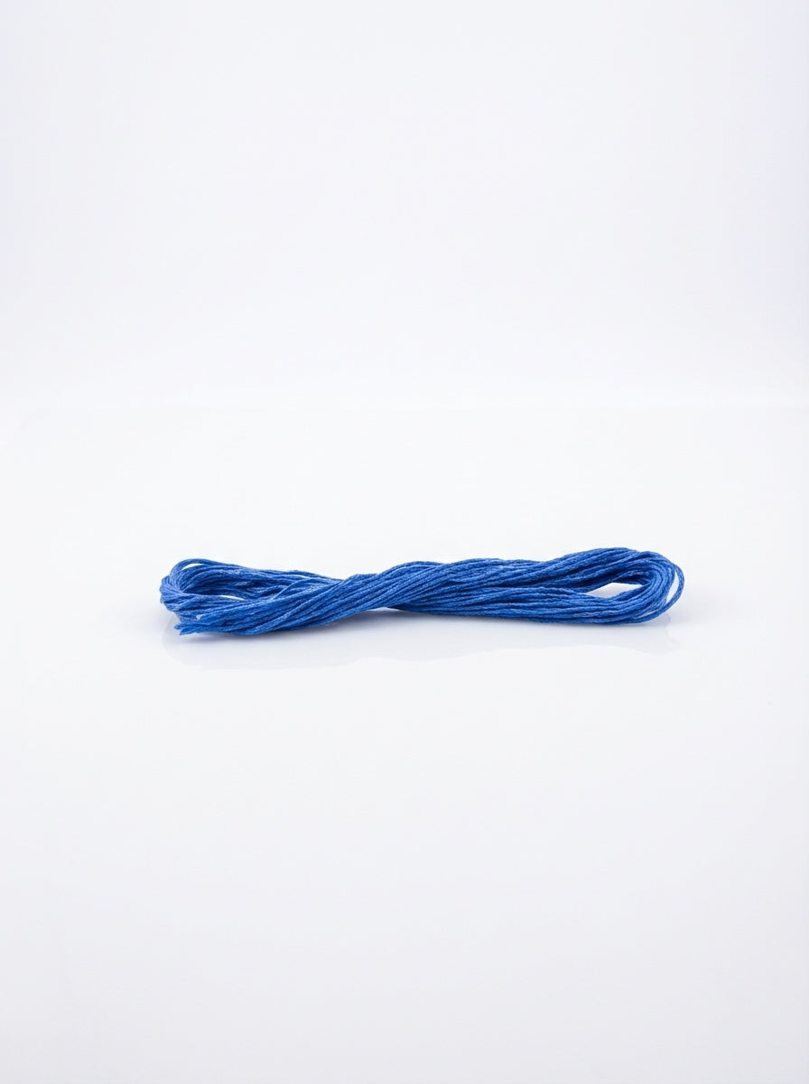 Studio shot of Dark Delft Blue cotton embroidery floss skein, showing its soft texture and color.