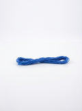 Studio shot of Dark Delft Blue cotton embroidery floss skein, showing its soft texture and color.