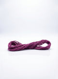Dark grape colored cotton embroidery floss skein, tightly wound and ready for crafting projects.