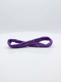 Studio shot of a dark lavender cotton embroidery floss skein, showcasing its color and texture.
