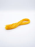 Studio shot of dark lemon yellow embroidery floss skein, showcasing its bright color and cotton texture