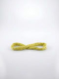 Skein of light avocado green embroidery floss made of soft cotton threads, close-up studio shot showing texture and color.