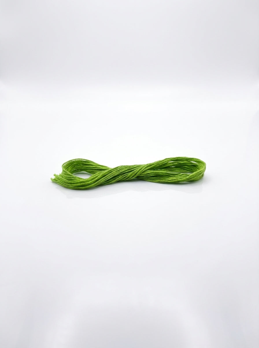 Chartreuse embroidery floss skein, tightly twisted cotton thread for crafting and sewing projects.