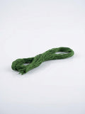 Dark forest green embroidery floss skein made of cotton, showcasing its color and texture.