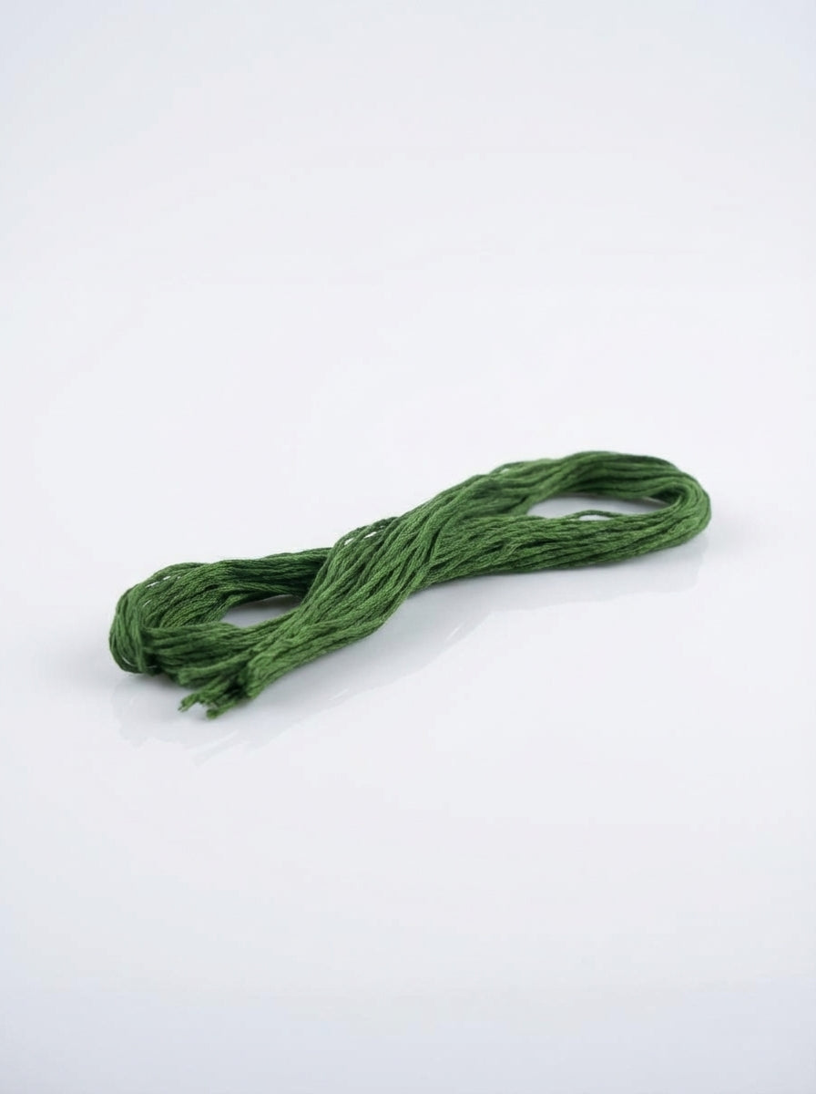 Dark forest green embroidery floss skein made of cotton, showcasing its color and texture.