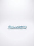 Studio shot of light antique blue cotton embroidery floss skein, showcasing its twisted texture and soft color.