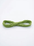 Skein of forest green cotton embroidery floss, neatly bundled, showing matte texture and rich color.