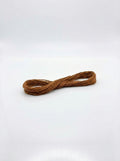 Studio shot of a golden brown cotton embroidery floss skein, wound in a figure-eight shape with a slight sheen.